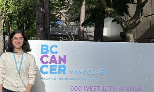 Rizzek standing beside BC Cancer Sign