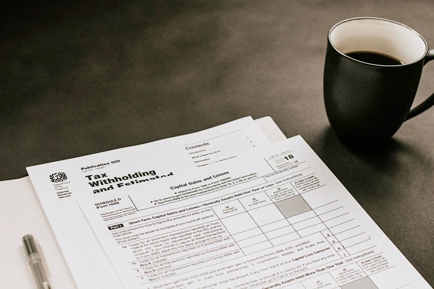 tax papers with a coffee mug next to it