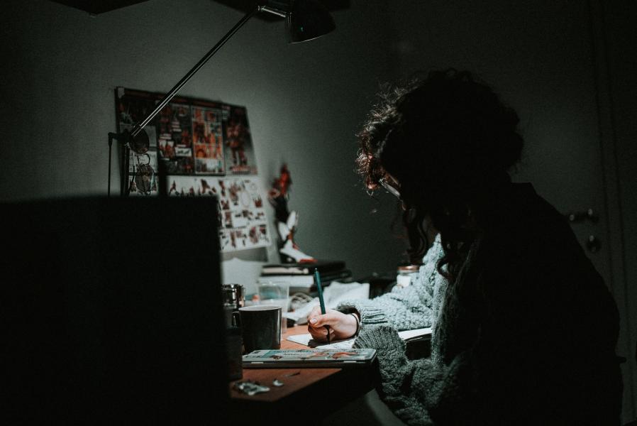 a girl working on a project in the dark