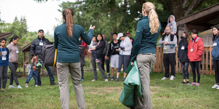 Two Learn-to Camp staff members talking to an audience