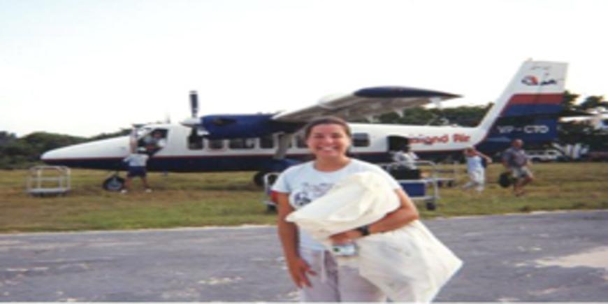 Laura posing in front an airplane