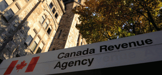 Picture of a building with the Canadian flag and a sign that says Canadian Revenue Agency
