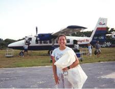 A girl standing in front of a plane