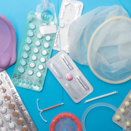 Assorted birth control on a blue table. 