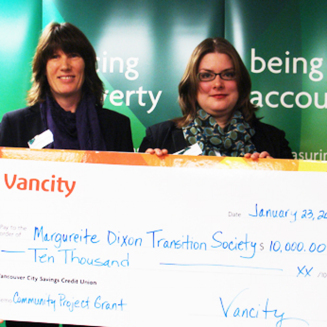 Nicole and other ladies holding a cheque ffrom a community project grant