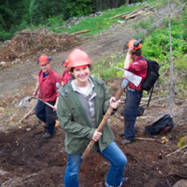 Carolyn smiling with co-workers; digging a fireguard for a controlled burn