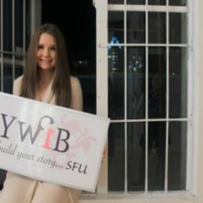 Kelly holding YWIB sign