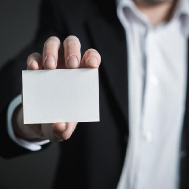 hands holding a blank business card