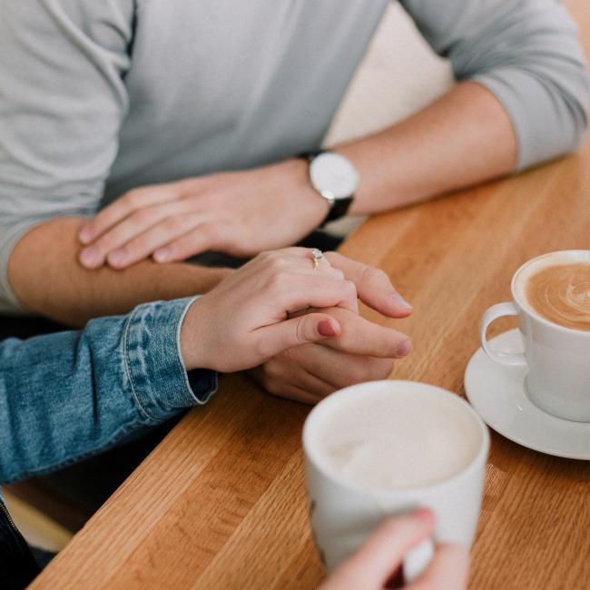 Two people having a coffee chat at a table