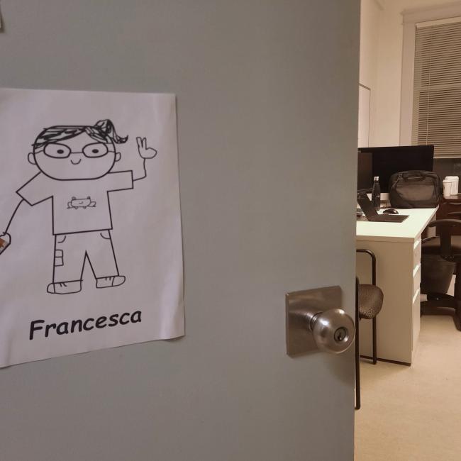 Self-portrait doodle on the door leading to an office desk