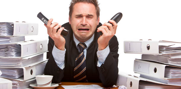 Person holding a telephone in each hand while crying