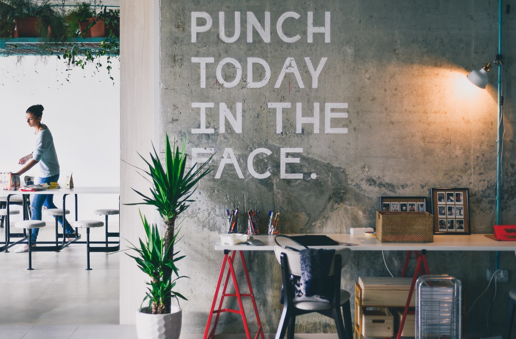 a motivational quote on the wall that says "Punch today in the face"