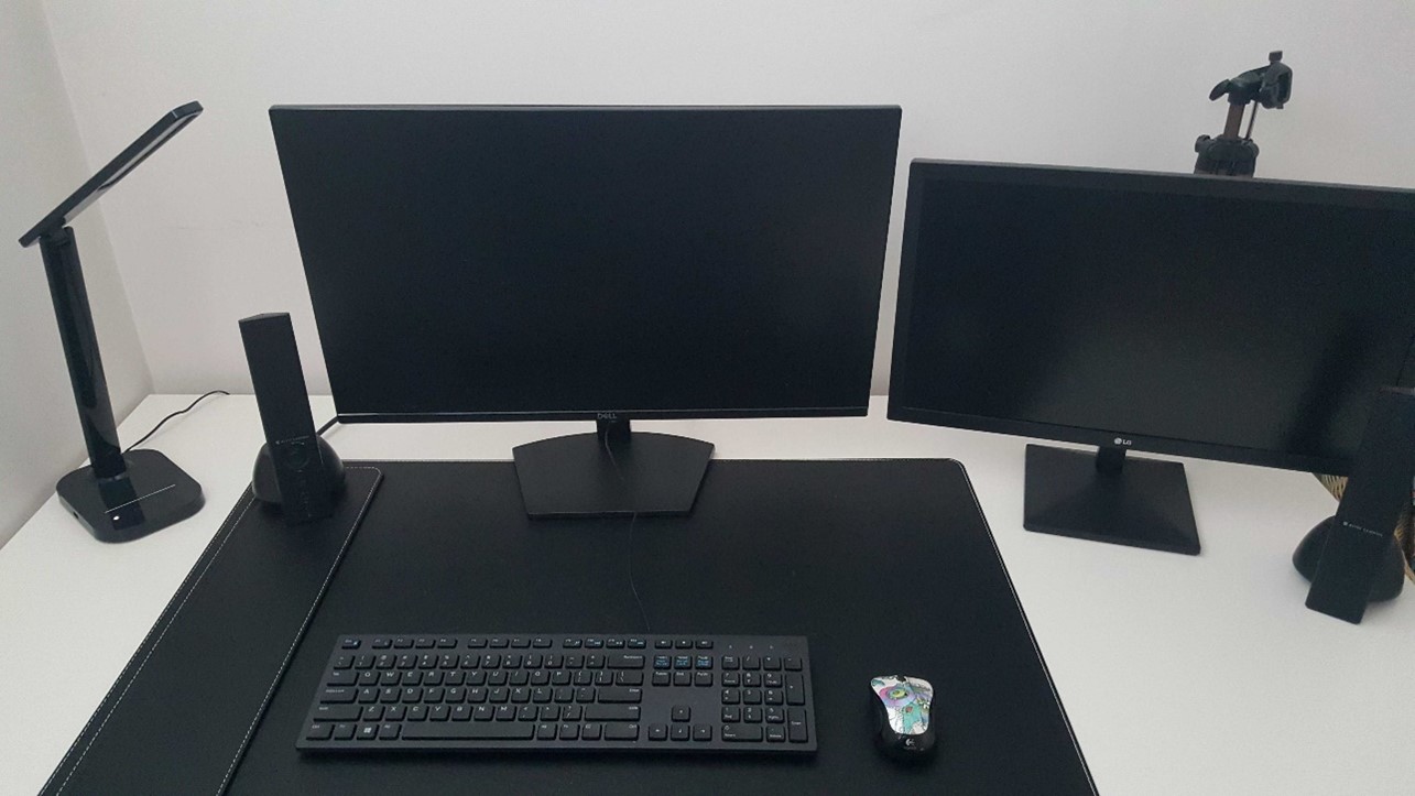 Matthew's workspace; two large monitors in front of a keyboard and mouse