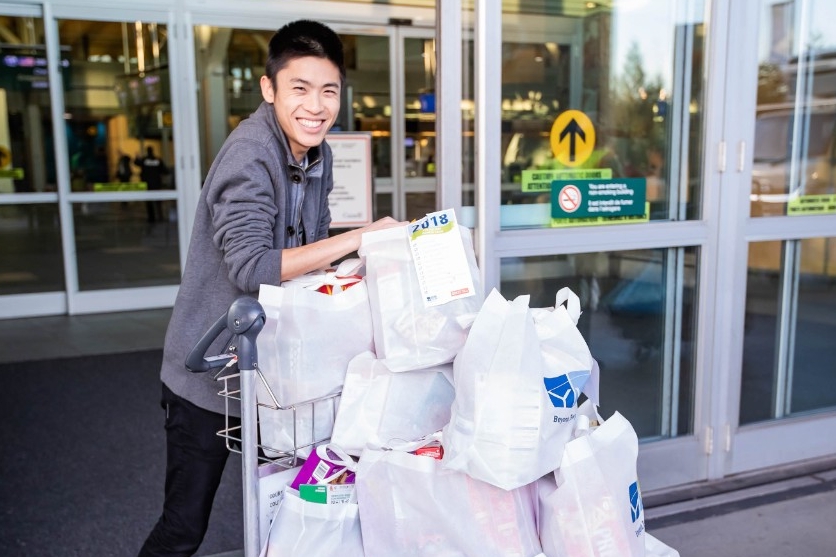 Wong with a cart full of grocery bags. 