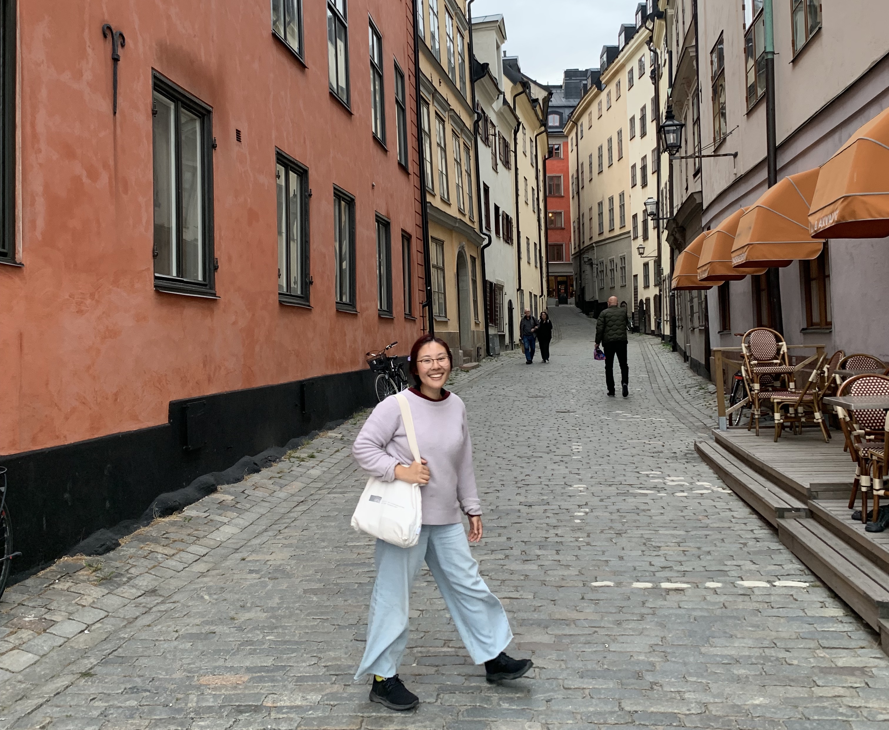 Kitty smiling and standing in a Stockholm street 