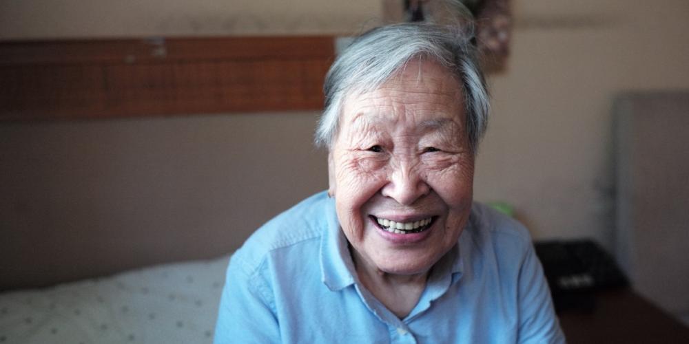 An older person smiling