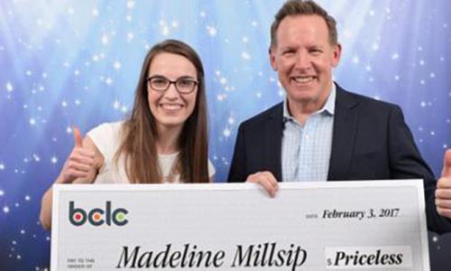 A student and CEO holding a large cheque 