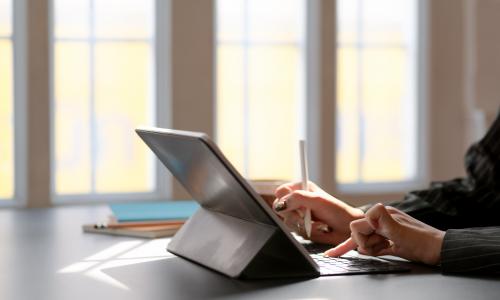 a side way image of someone using a Microsoft surface