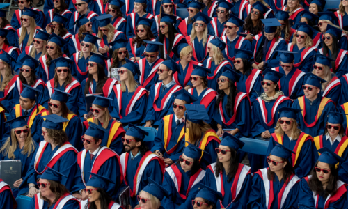 Sfu graduates sitting beside each other during convocation ceremony 