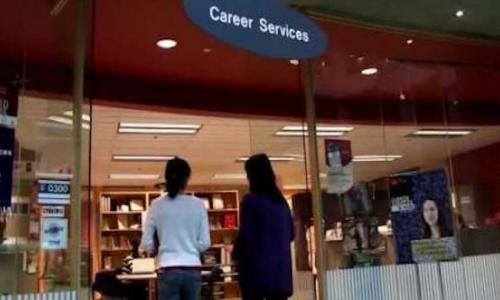 Two students are entering the office of SFU Career and Volunteer Services. 