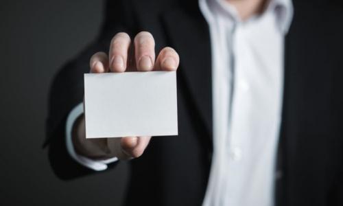 hands holding a blank business card