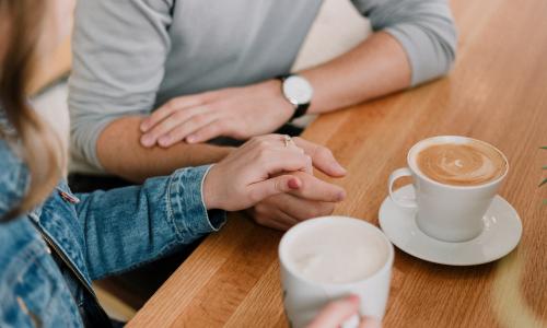 Two people having a coffee chat at a table