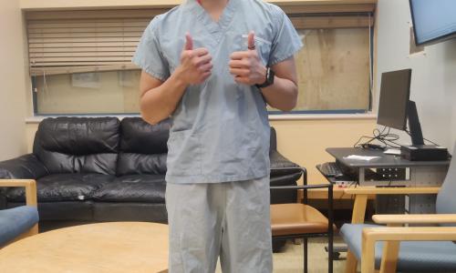 Raven wearing scrubs to enter the Operating Room as part of a research study