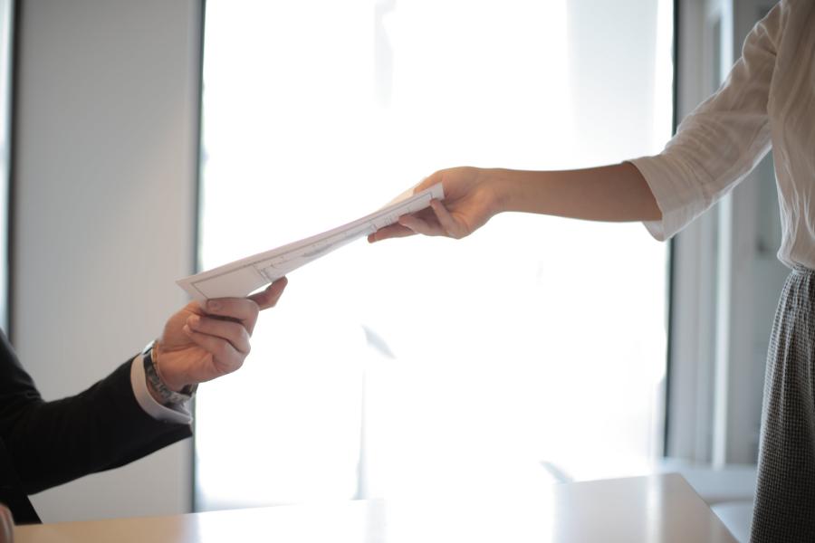a person handing in their documents