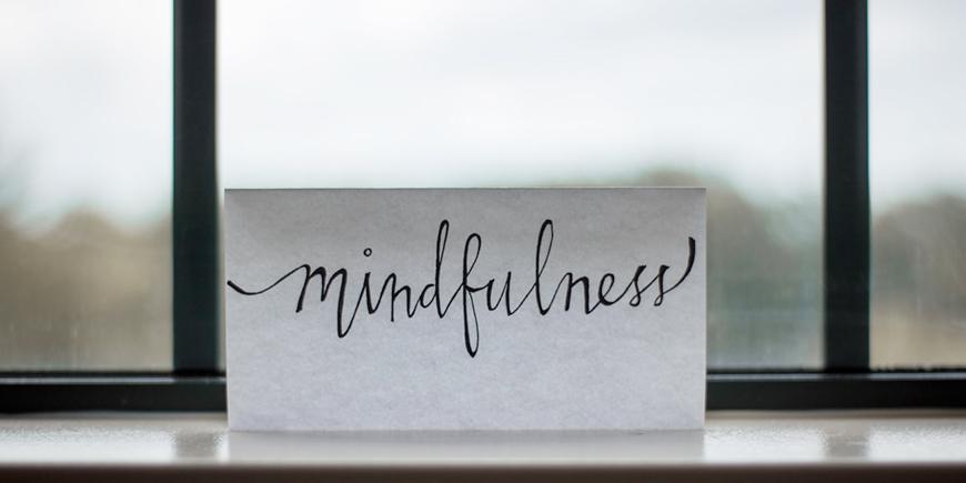 a letter placed on a windowsill with the text that says mindfulness
