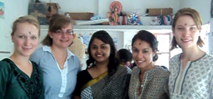Silvia, Lindsay, Christine and Martyna smiling at the camera with their co-worker, Diya