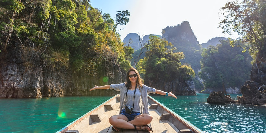 Woman sitting in a small boat while floating on a lake