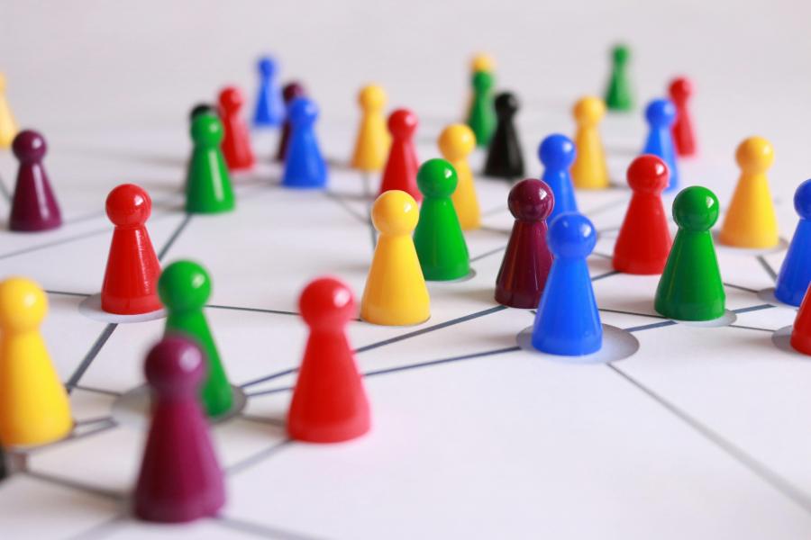 Representation of Networking - clusters of multicoloured board game pieces