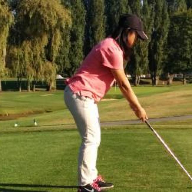 Natalie playing golf.