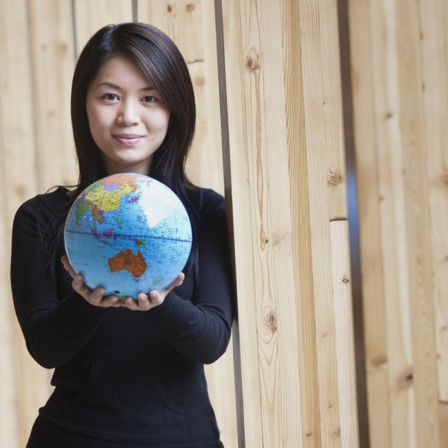Student holding a globe