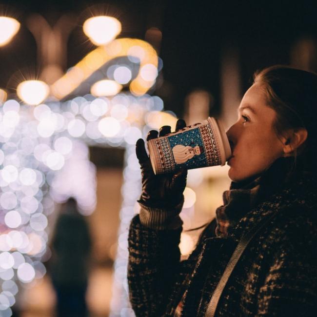 a girl drinking coffee during Christmas time