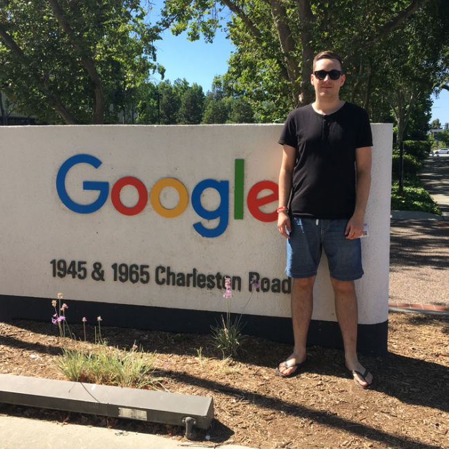Paull standing beside the Google headquarters sign