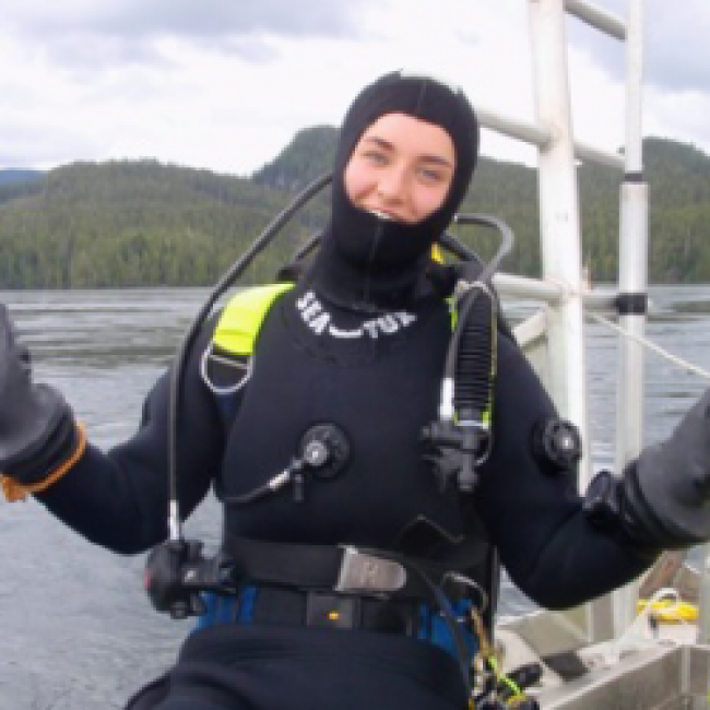 Jill in scuba diving gear on a boat 