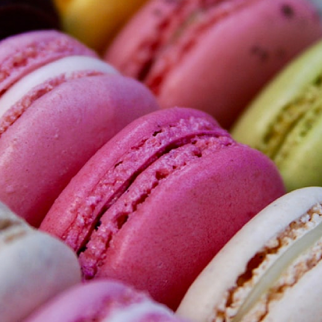Several colourful macarons in a box