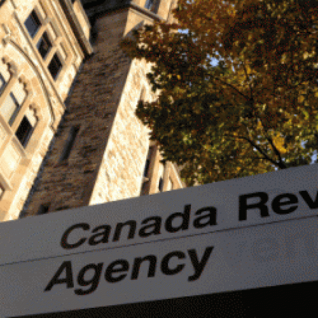 Picture of a building with the Canadian flag and a sign that says Canadian Revenue Agency