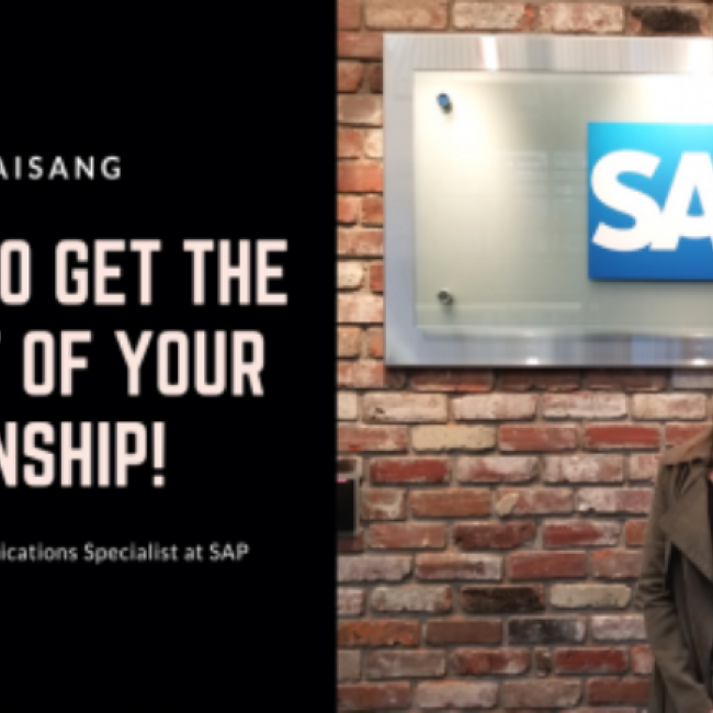Pat Chaisang standing in front of SAP's sign