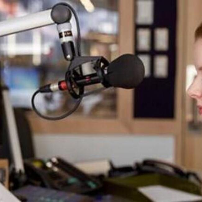 girl with headphones on in radio station