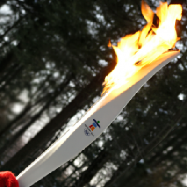 A person holding a Olympic torch 