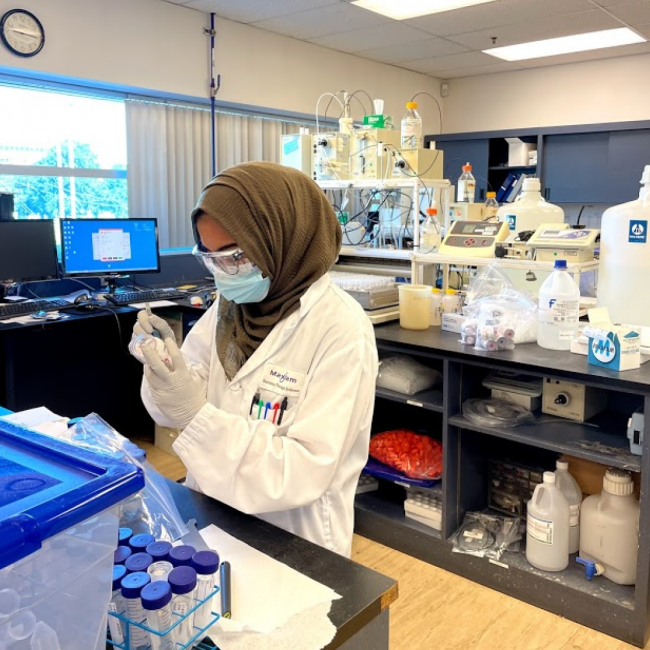 Lamees Dhalla working in a lab.