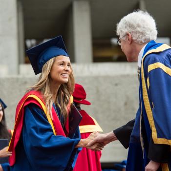 SFU graduate shaking hands with faculty member