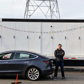 Rick standing in front of a Tesla car