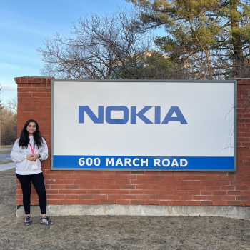 An image of a girl standing next to Nokia's board 